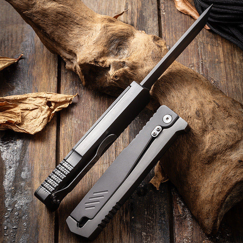 Two industrial-style all-metal folding knives displayed on a weathered wood background, featuring silver and matte black finishes. Rugged design, ideal for outdoor EDC use and everyday tool handling.