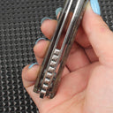 Close-up of the side mechanical structure of the abalone folding knife, clearly showing the handle thickness, flipper tab design, and precision ball bearing system for smooth and secure operation.