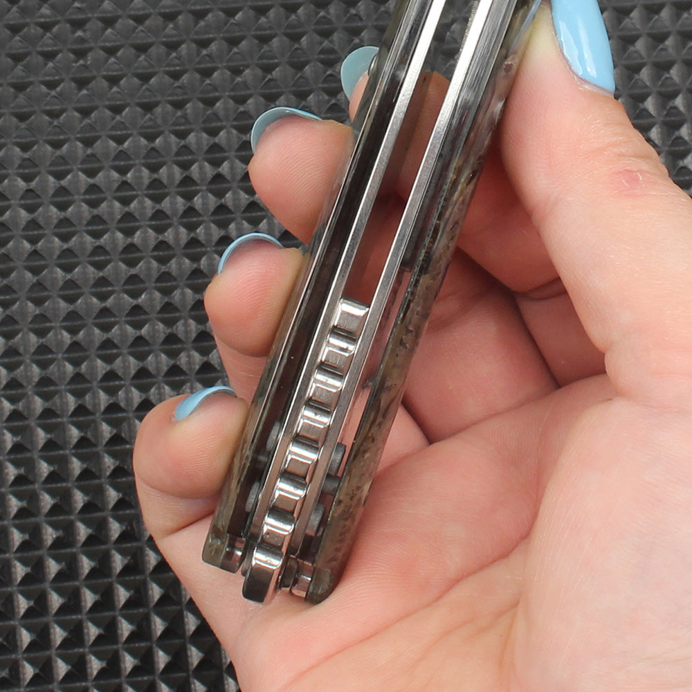 Close-up of the side mechanical structure of the abalone folding knife, clearly showing the handle thickness, flipper tab design, and precision ball bearing system for smooth and secure operation.