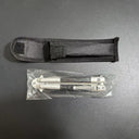 A black nylon sheath and a closed balisong butterfly knife sealed inside a plastic bag, displayed on a dark background.