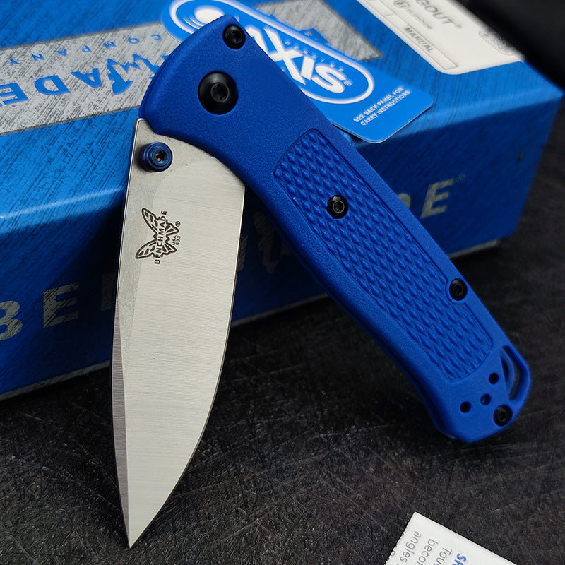 An open Benchmade folding knife with a blue handle, silver blade, and blue thumb stud, displayed with its blue box.
