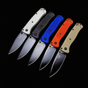 Five open Benchmade folding knives with white, black, blue, orange, and tan handles, displayed on a black background.