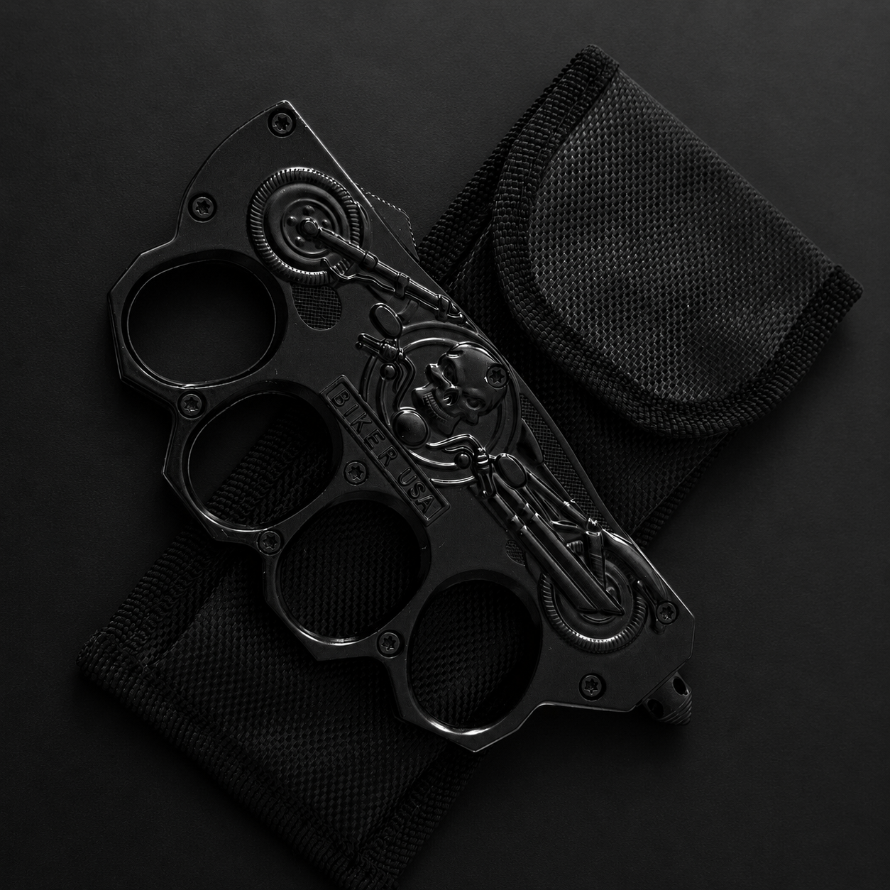 Black BIKER USA four-finger multi-functional portable EDC tool, featuring skull and motorcycle style design, paired with a black nylon carry pouch.