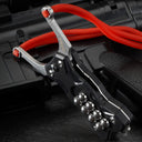 A black G10 handle EDC slingshot with a stainless steel fork, red high-elastic band, and steel ball storage, displayed on a dark tactical firearm background.