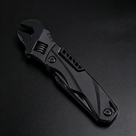 A black folding adjustable wrench with a textured, knife-style handle, displayed on a dark background.