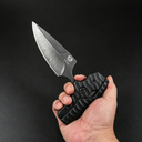 A hand holding an open black folding knife with a stonewashed silver blade and a textured handle, displayed against a dark background.