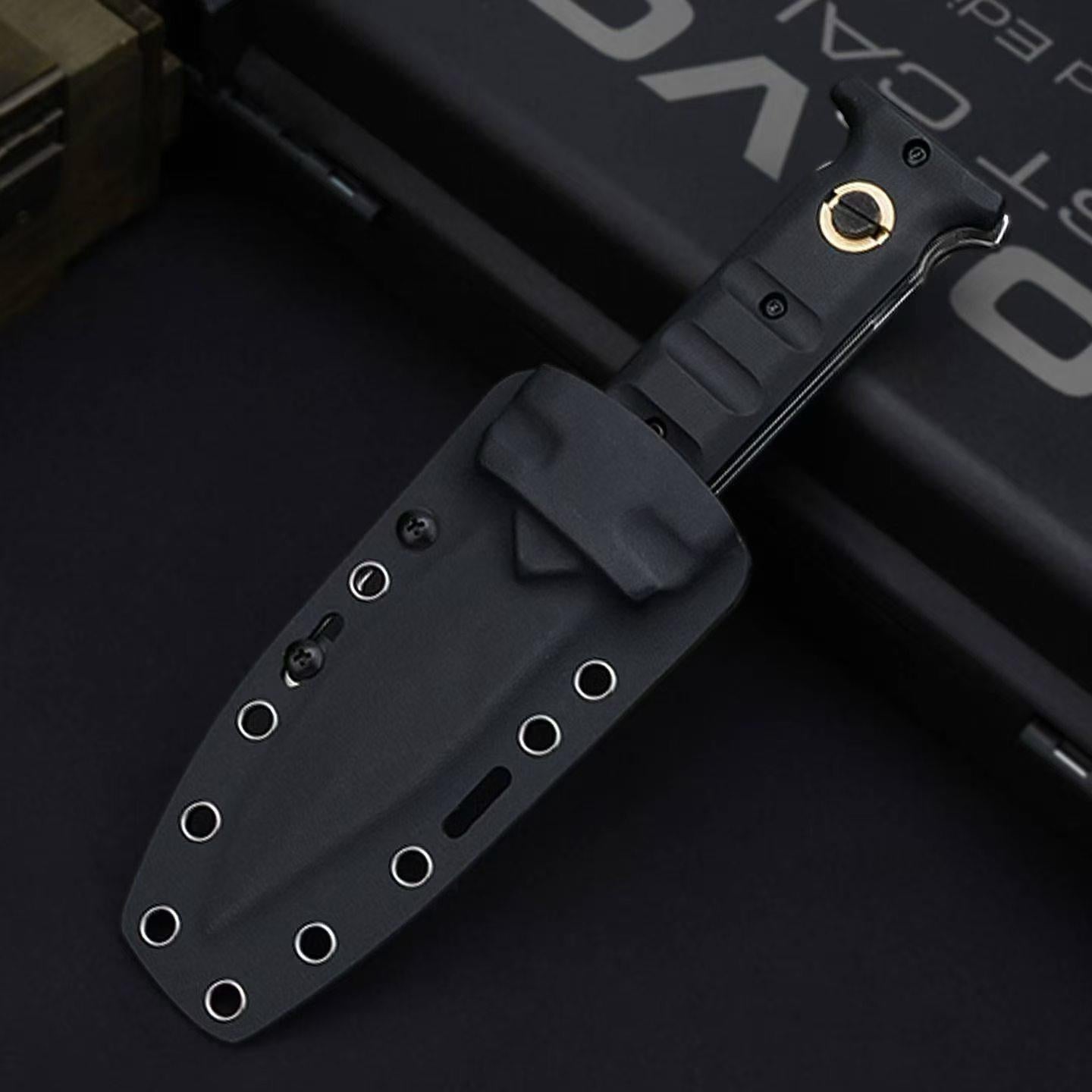 A closed black folding knife with a gold pivot screw, sheathed inside a black hard sheath with multiple eyelets, displayed on a dark background.