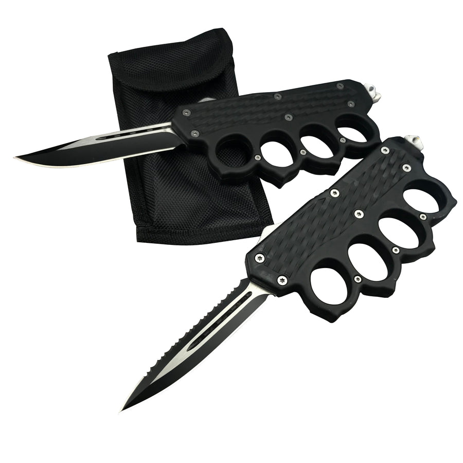 Two open black OTF knives with knuckle duster handles and black blades, one plain edge and one serrated, displayed next to a black nylon sheath on a white background.