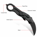A black mechanical folding karambit knife open on a white background, with red lines labeling its features: Lanyard Hole, Finger Ring, Ergonomic Handle, Bottle Opener, and Blade.
