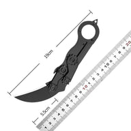 A black mechanical folding karambit knife with a finger ring and articulated arms, shown with dimension lines indicating a total length of 19cm and a blade length of 5.5cm, next to a ruler on a white background.