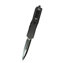 Black OTF knife with a pocket clip and a silver blade, shown on a white background.
