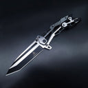 An open tactical folding knife with a black Tanto blade and a two-tone black and silver skeletonized handle, displayed on a dark background.