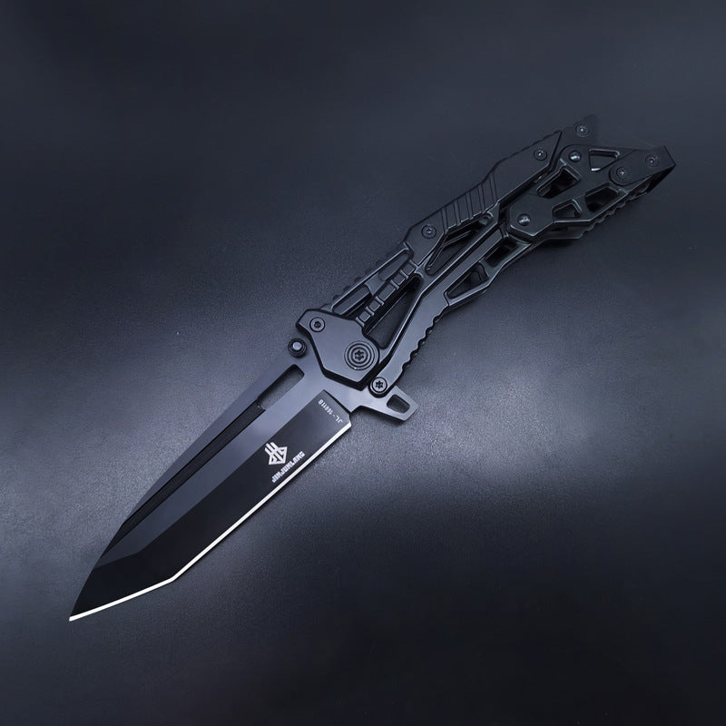 An open all-black tactical folding knife featuring a Tanto blade and a skeletonized handle, displayed on a dark background.