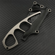 A Böker Plus skeletonized neck knife partially inserted into its black leather and polymer sheath, displayed on a dark carbon fiber patterned background.