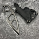 A Böker Plus skeletonized neck knife with a finger ring, displayed separately from its black leather sheath on a mottled grey textured background.