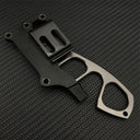 The back side of a black sheath for a Böker Plus neck knife, showing the polymer belt clip or mounting attachment, with the knife partially inserted, on a carbon fiber background.