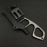 The back side of a black sheath for a Böker Plus neck knife, showing the polymer belt clip or mounting attachment, with the knife partially inserted, on a carbon fiber background.