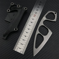 A Böker Plus skeletonized neck knife with its black leather sheath displayed next to a metal ruler on a carbon fiber textured background for size reference.