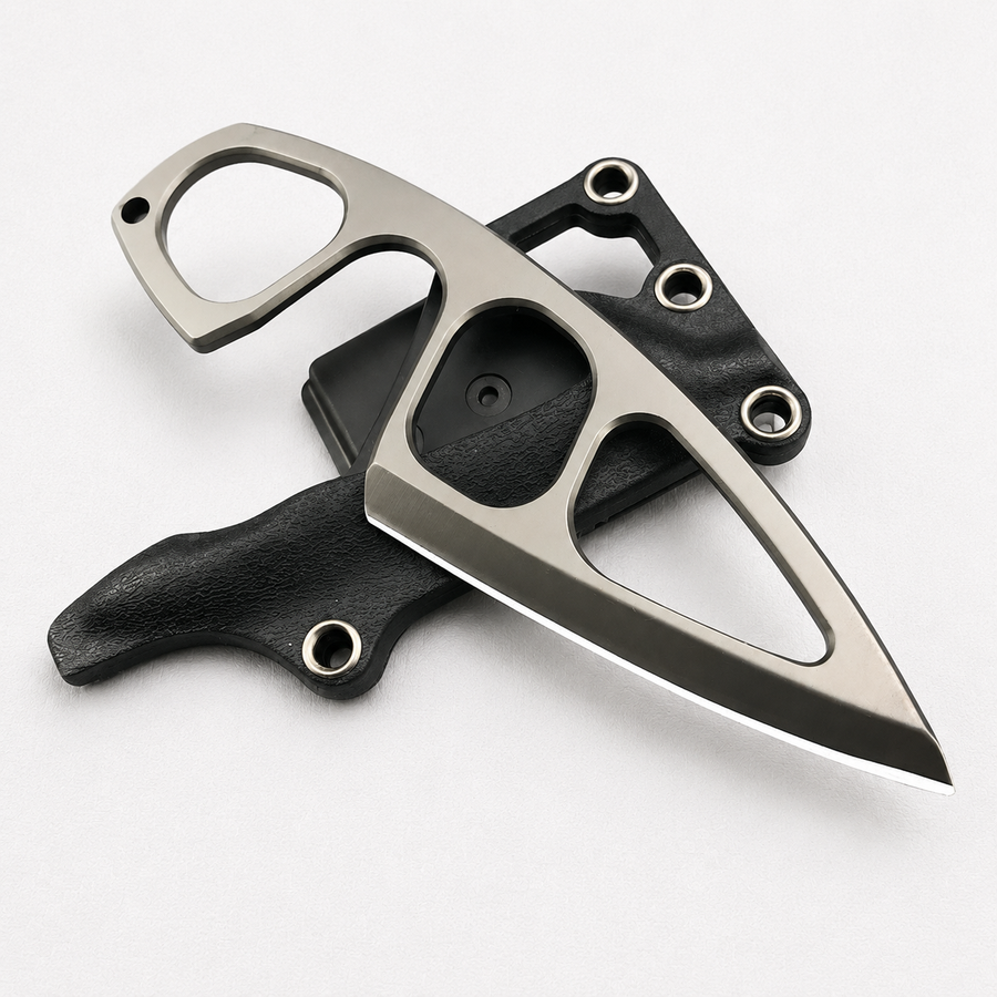 A Böker Plus skeletonized fixed blade knife with a finger ring and hollow cutouts, displayed on its black leather and polymer sheath against a white background.