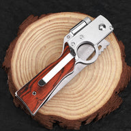 A closed folding knife featuring a wooden handle, silver frame, circular finger ring, and locking mechanism, displayed on a round wooden log slice.