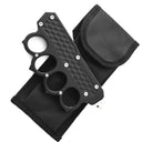 A closed black knuckle duster OTF knife with textured grooves, displayed next to its black nylon carrying sheath on a white background.