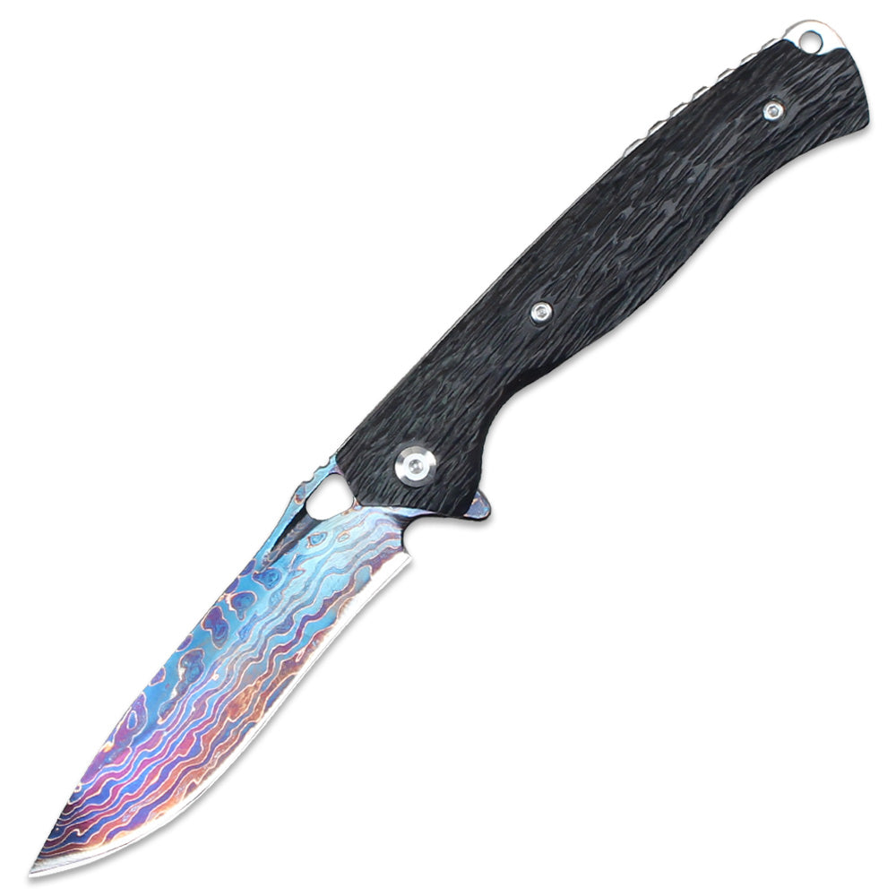 Displayed on a white background, this folding knife features a stunning colorful Damascus/Titanium blade paired with a black textured handle, combining outdoor utility with collectible aesthetics.