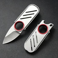 An open and a closed EDC keychain folding knife with a silver stainless steel body and red ring, displayed on a dark textured surface.