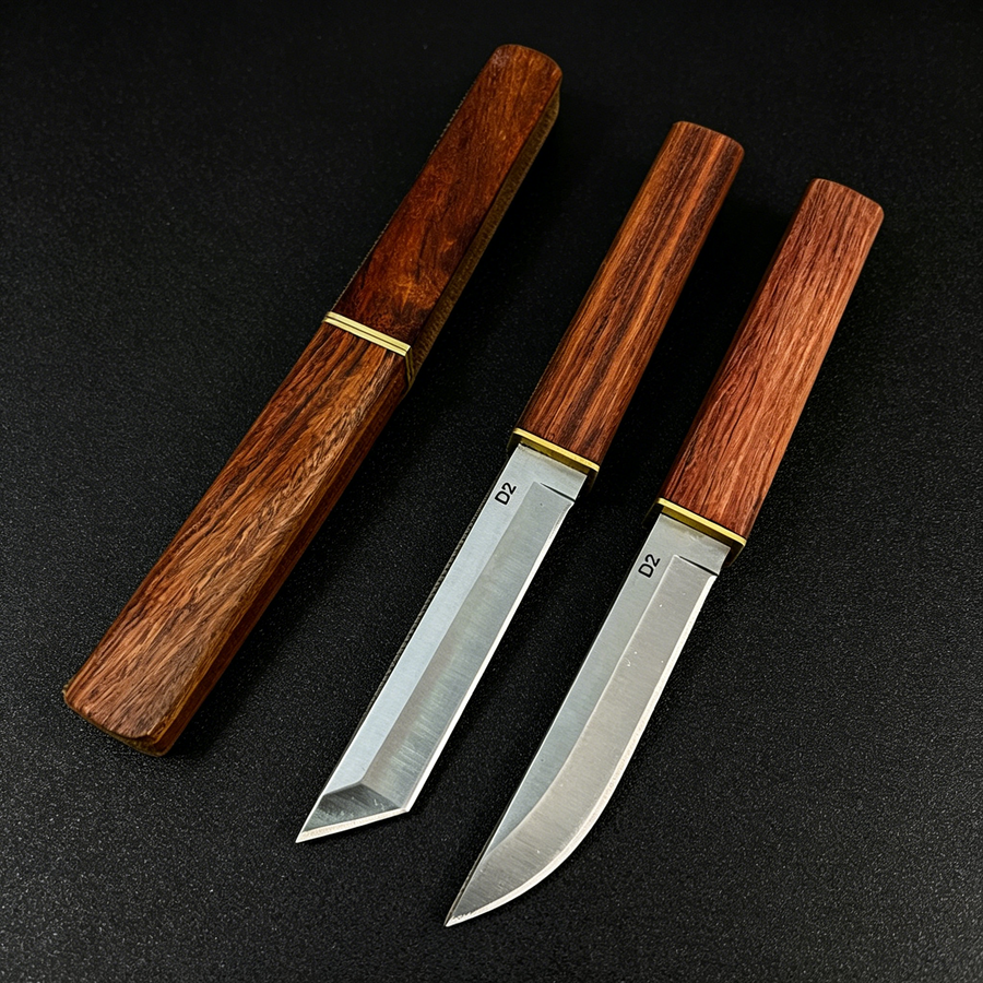 An empty wooden sheath on the left, and two D2 steel fixed blade knives with wooden handles and brass accents on the right. One features a tanto-style blade, and the other features a curved blade, displayed on a dark textured surface.