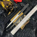 A tactical layout of two slim folding knives with black and silver blades, displayed with a black sheath, black pouch, metal ruler for size reference, and decorative props on a dark rocky background.