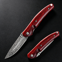 An open and a closed folding knife featuring a patterned damascus steel blade and polished red wooden handles, displayed on a dark textured surface.