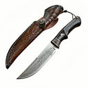 Handmade Damascus steel hunting knife with black wood handle and brass guard, paired with a hand-carved brown leather sheath featuring a distinctive turquoise button, designed for outdoor use or as a collector's gift.