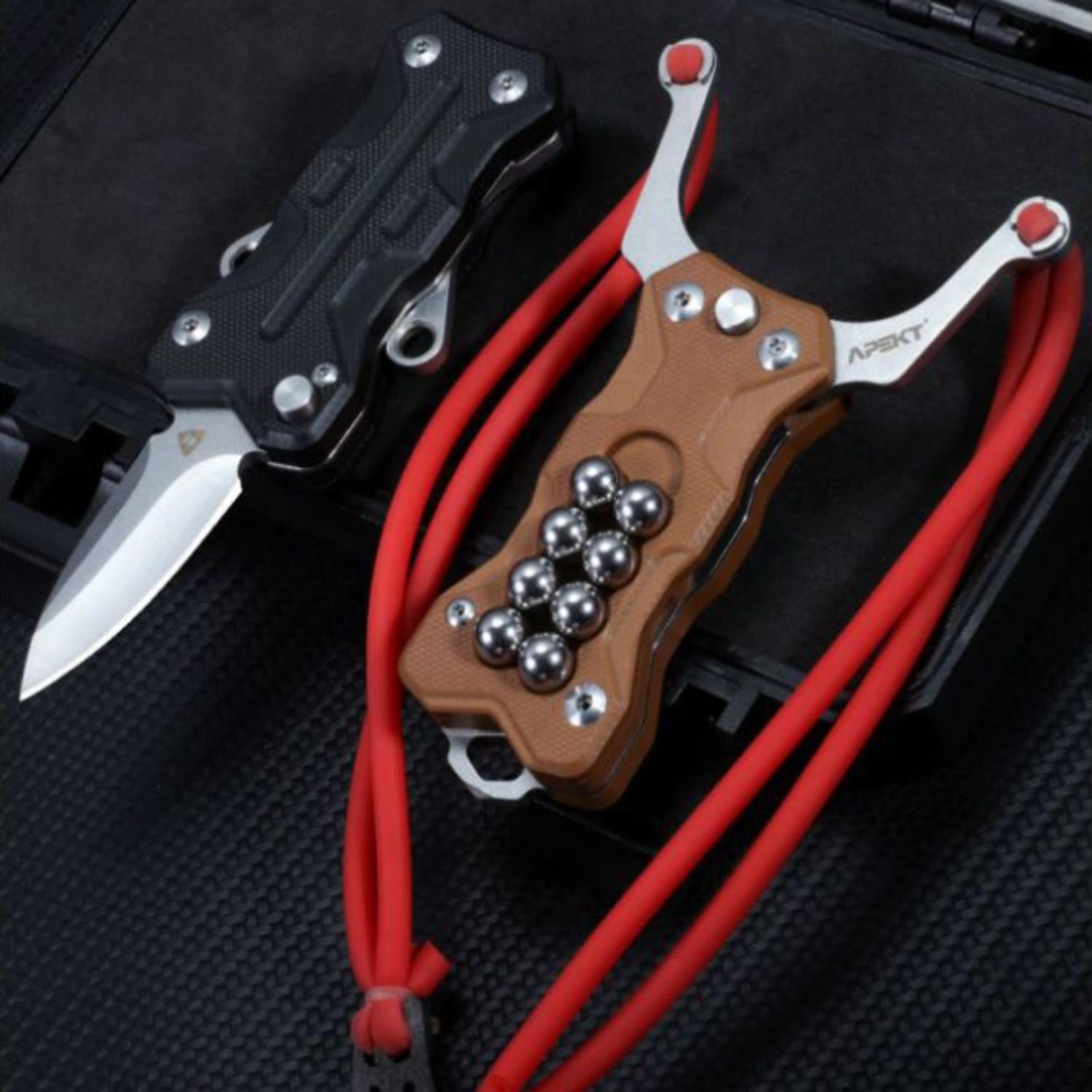 Two EDC slingshot knives displayed side by side; the black one is in the knife mode, and the tan one is in the slingshot mode with a red band.