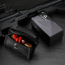 A product packaging display showing a tan EDC slingshot with red bands tucked inside a black nylon pouch, placed next to its black and silver APEXT brand packaging box, all set against a dark tactical background.