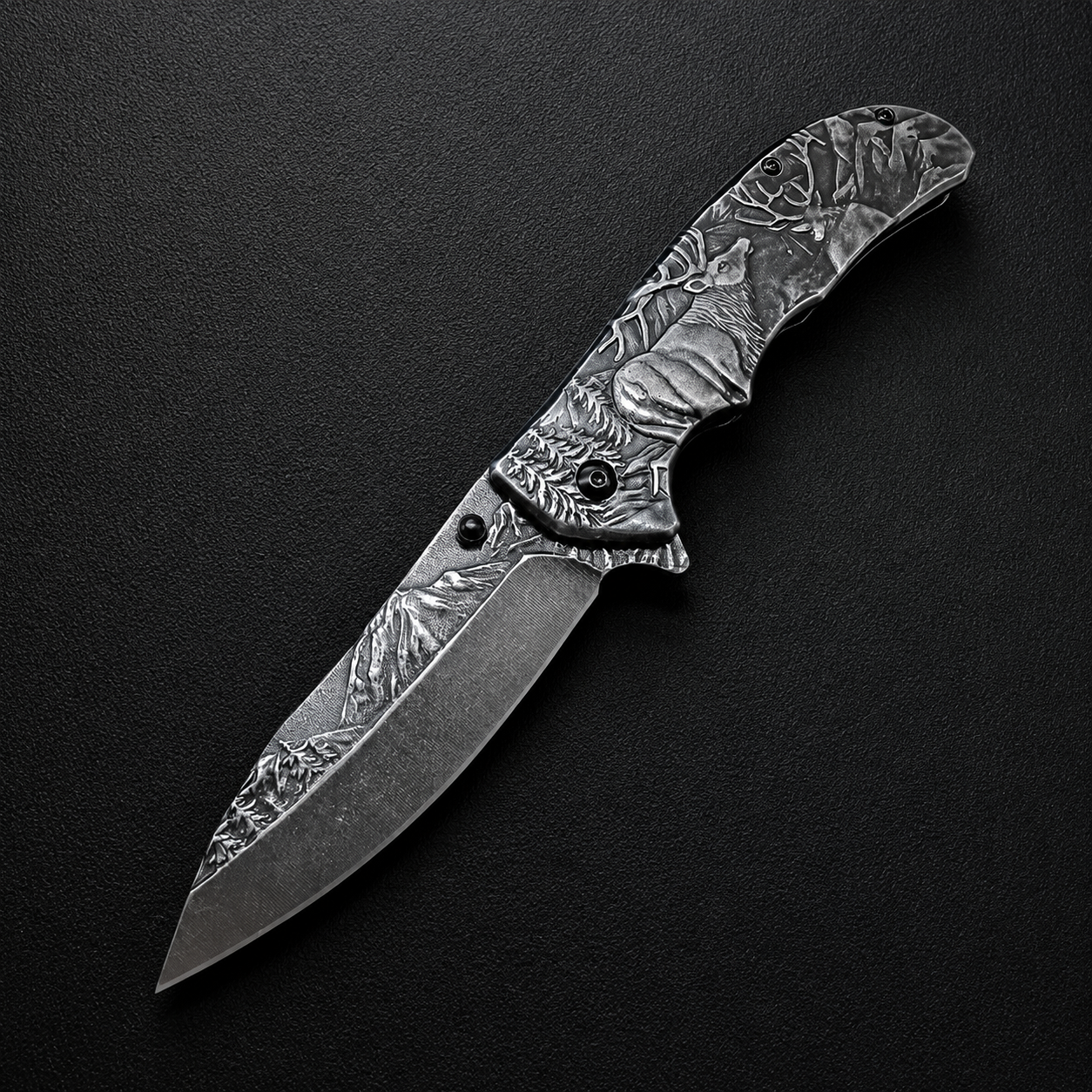 An open folding knife featuring intricate engraving of a deer and forest landscape on the blade and handle, displayed on a dark textured surface.