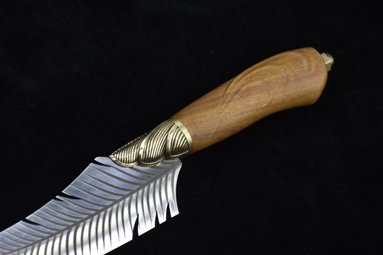 A close-up view of a fixed blade knife showing the ridged brass bolster and polished wooden handle with a decorative brass end cap.