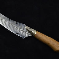 A side profile view of a curved fixed blade knife, emphasizing the sweeping shape of the silver feather blade and the wooden handle.