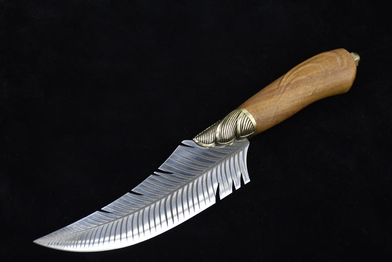 A full side view of a curved fixed blade knife with a feather-patterned blade, a ridged brass bolster, and a polished wooden handle, displayed on a dark background.