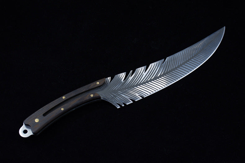 A full profile view of a curved fixed blade knife featuring detailed feather engraving, a dark wood handle with brass pins, and a silver lanyard hole.