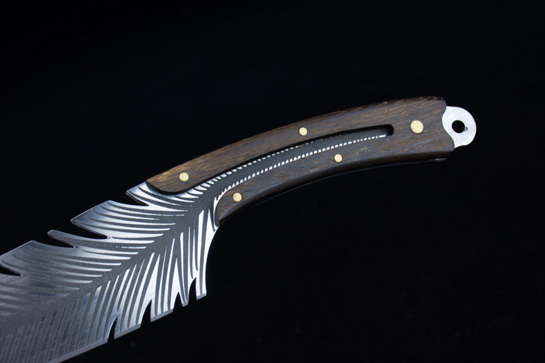 A close-up of the dark wood handle and silver blade with intricate feather-like serrations and brass pin accents.