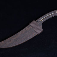 A full view of the dark wooden sheath for the feather blade knife, showing the wrapped cord and matching wood grain.