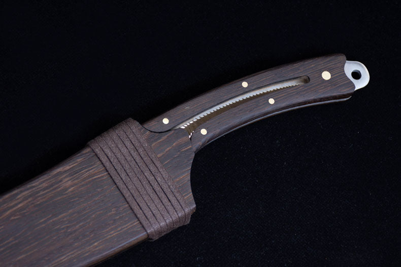 A close-up of the dark wooden sheath and handle, highlighting the matching wood grain, brass pins, and wrapped cord detail.