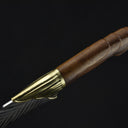 A close-up of the rear end of the wooden handle, featuring a decorative brass pommel on a feather blade knife.