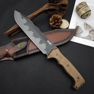 A fixed blade knife with a wooden handle and hammered blade, resting on a textured black surface next to a customized leather sheath, pine cone, hemp rope, and wood drift.