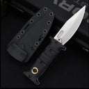 An open folding knife with a black handle featuring a gold pivot and a silver blade with a fuller, displayed next to a black hard sheath on a dark background.