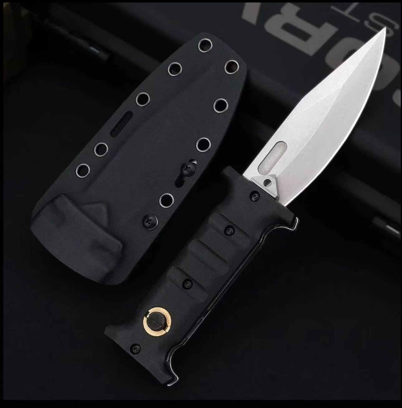 An open folding knife with a black handle featuring a gold pivot and a silver blade with a fuller, displayed next to a black hard sheath on a dark background.