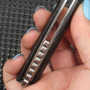 Close-up of the folding knife's side mechanical structure, clearly showing the bearing system and liner/frame lock mechanism, highlighting smooth opening and solid construction.