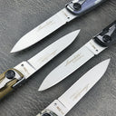 A close-up view of four folding knife blades showing the engraved brand logo and model text on the bright steel surface.