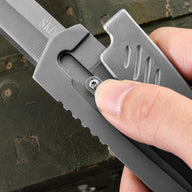 Close-up of the full-metal gravity folding knife’s mechanical structure, with the thumb sliding along the guide rail groove to use inertia for deploying the blade, delivering smooth operation and a strong mechanical feel.