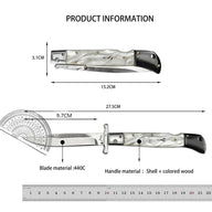 Product information chart for an Italian stiletto folding knife. The image shows a closed knife with a 15.2cm total length and 3.1cm height, and an open knife with a 27.5cm total length and 9.7cm blade length. Annotations indicate the blade material is 440C steel and the handle material is shell and colored wood.