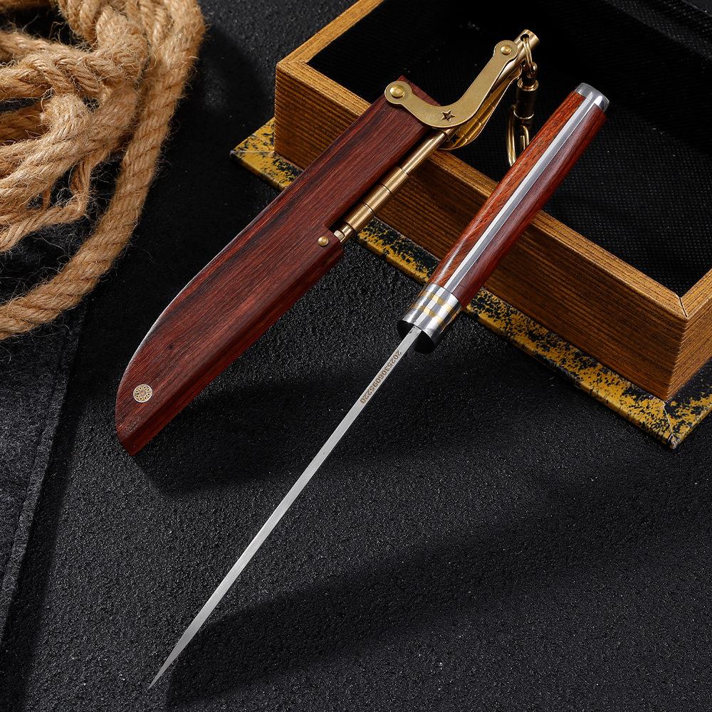 A folding knife with an M390 blade inserted into its wooden sheath, featuring a brass mechanical lock and key ring, displayed on a dark background with rope and a wooden box.